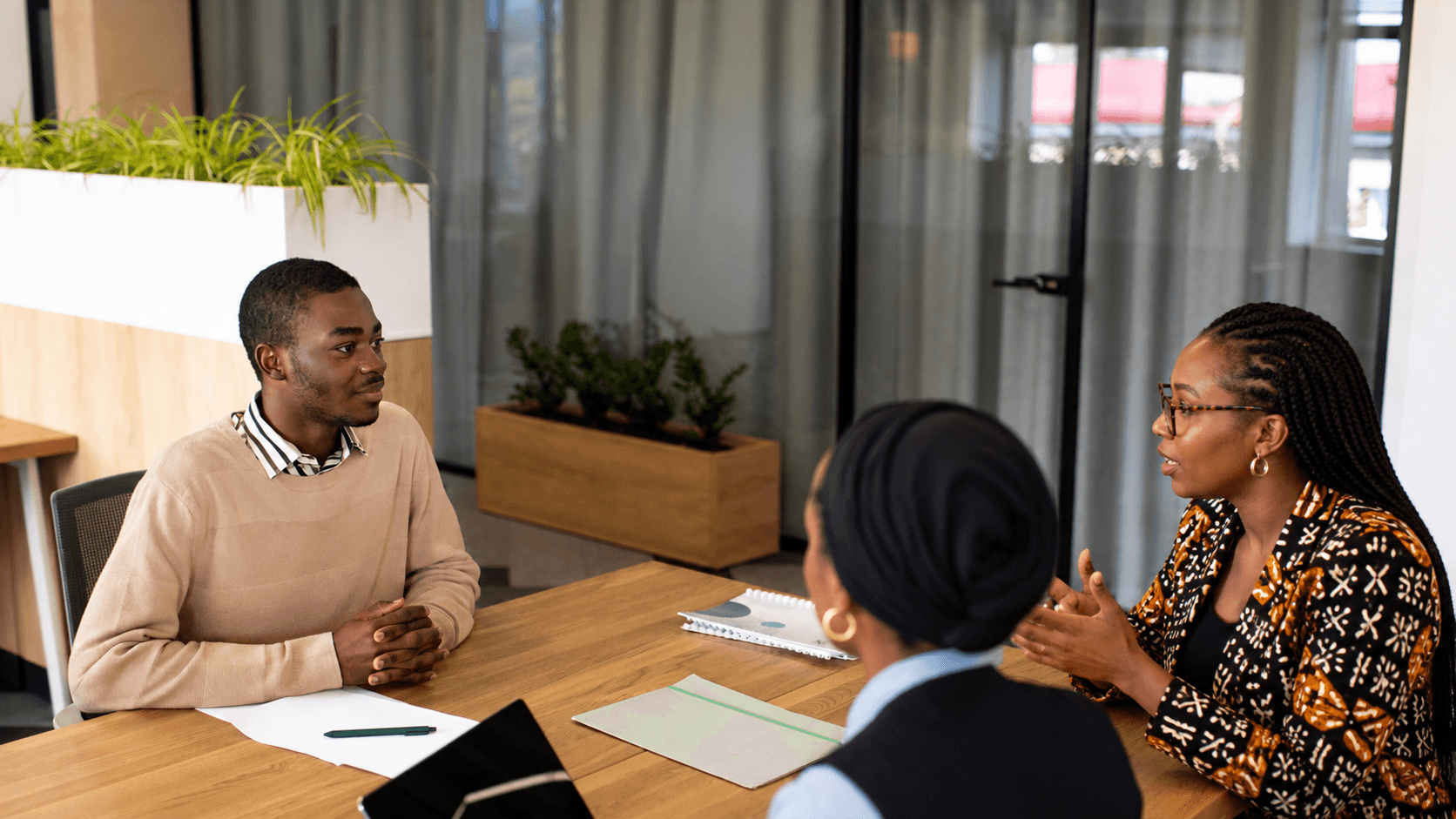 Colleagues in a discussion around a meeting table.