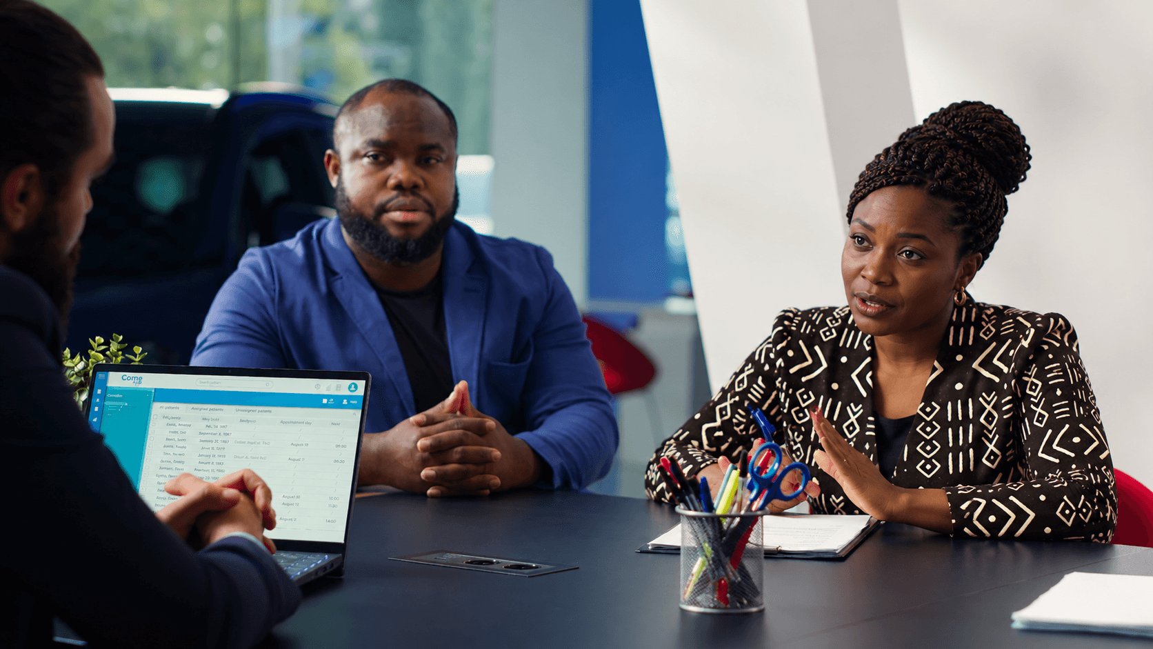 Colleagues in conversation around a boardroom table.