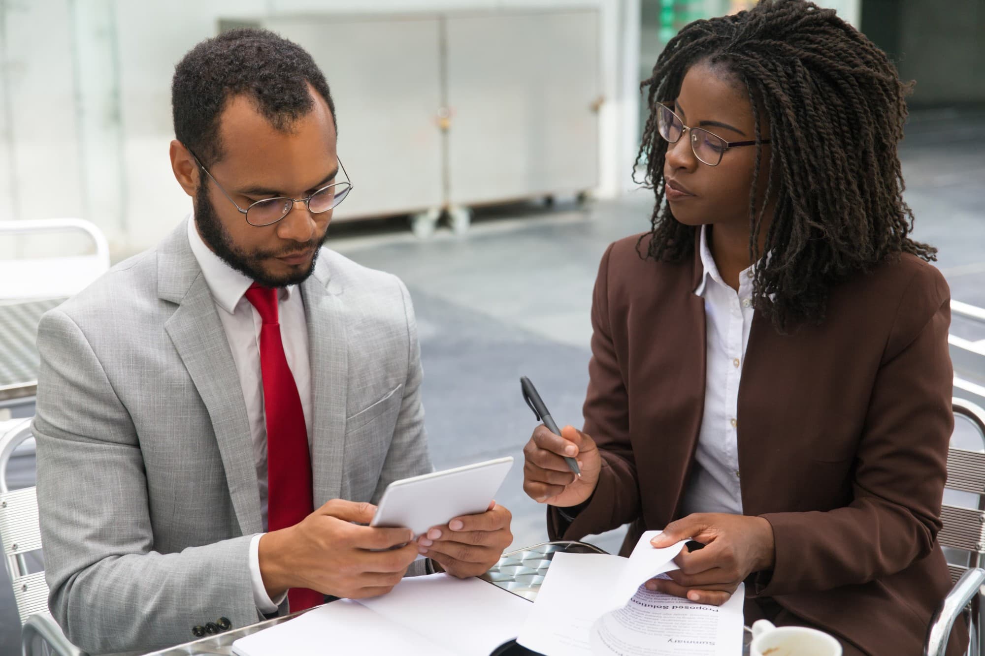 Two colleagues reviewing a proposal together.
