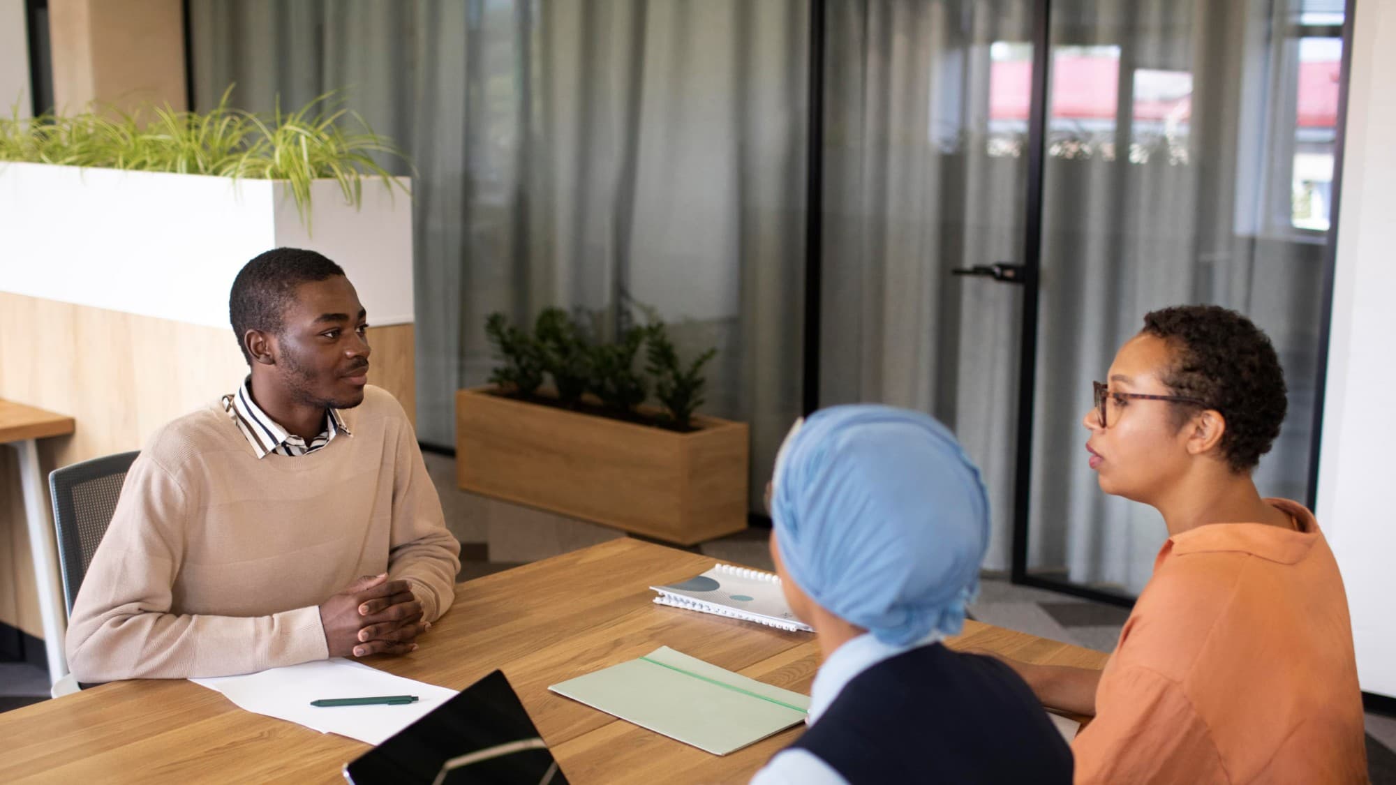 Colleagues in a discussion around a meeting table.