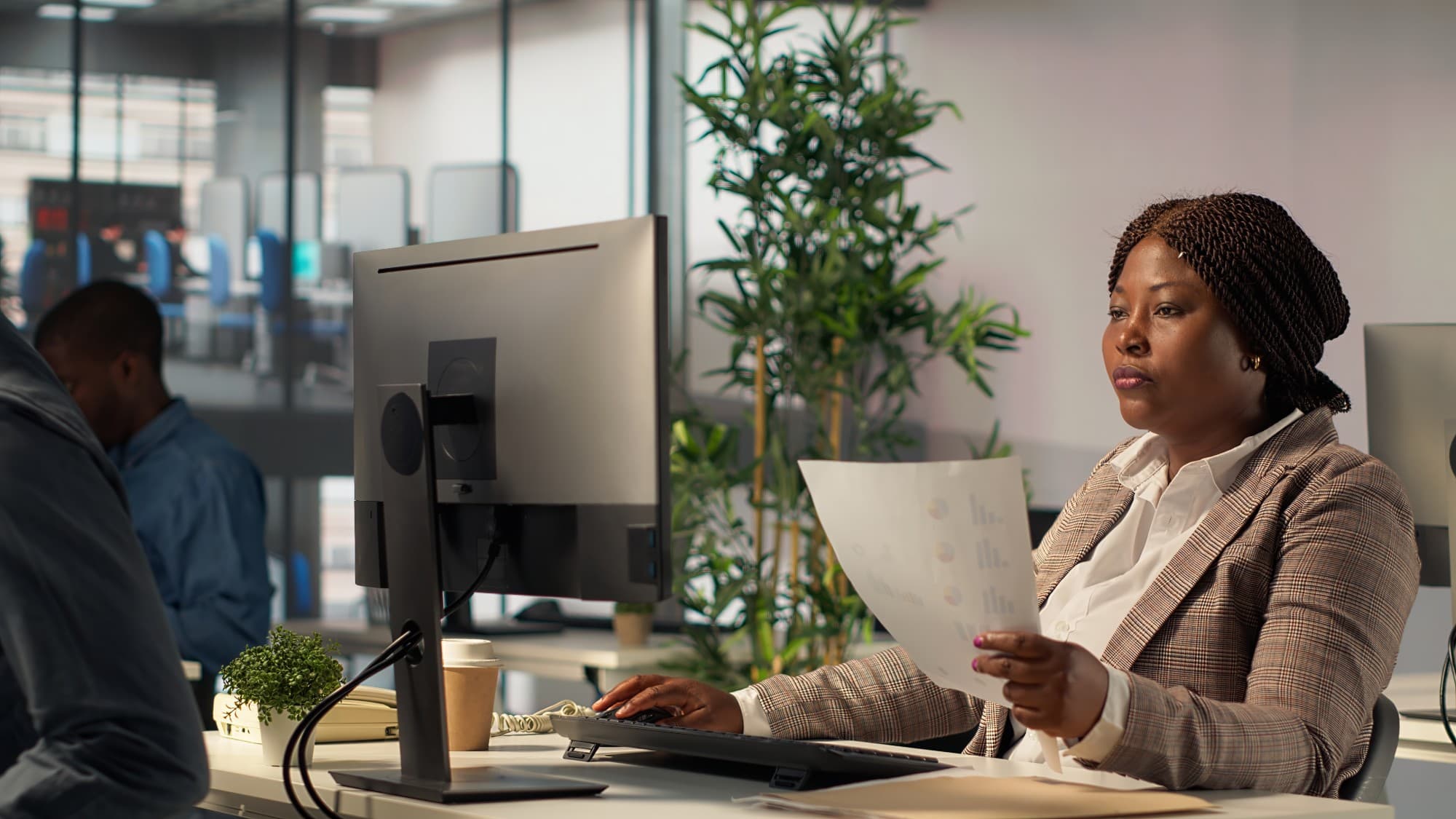 A consultant reviewing performance charts at her desk.